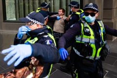 MELBOURNE, AUSTRALIA - MAY 10: A group of police violently arrest a man but later released him during COVID 19 Anti Lockdown protest at Parliament House on 10 May, 2020 in Melbourne, Australia. (Photo by Speed Media/Icon Sportswire)