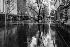 A view of a water sogged Swanston Street devoid of life during COVID-19 in Melbourne, Australia. Victoria has recorded 14 COVID related deaths including a 20 year old, marking the youngest to die from Coronavirus in Australia, and an additional 372 new cases overnight.